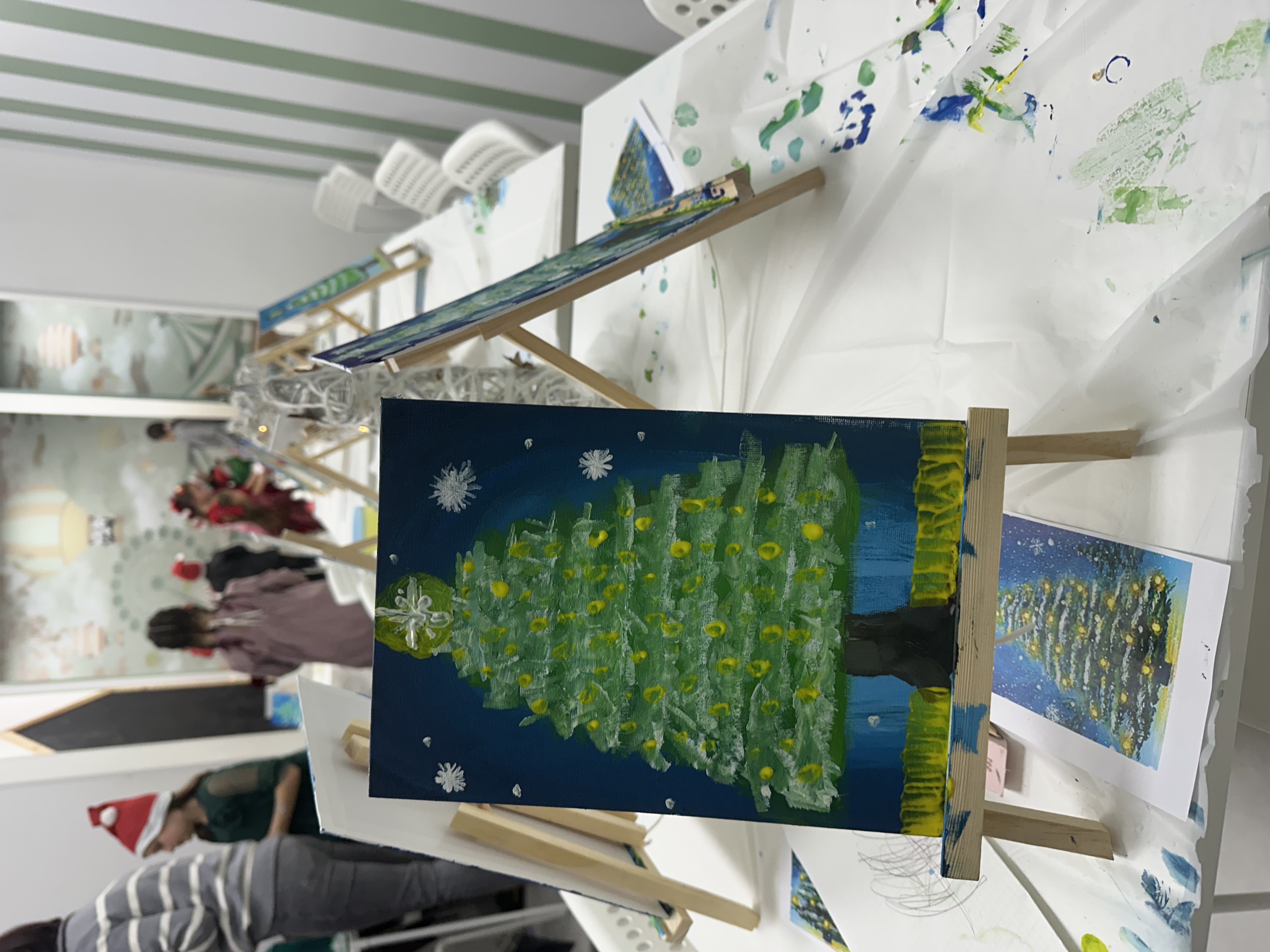 Winter holidays workshop — children painting Christmas trees